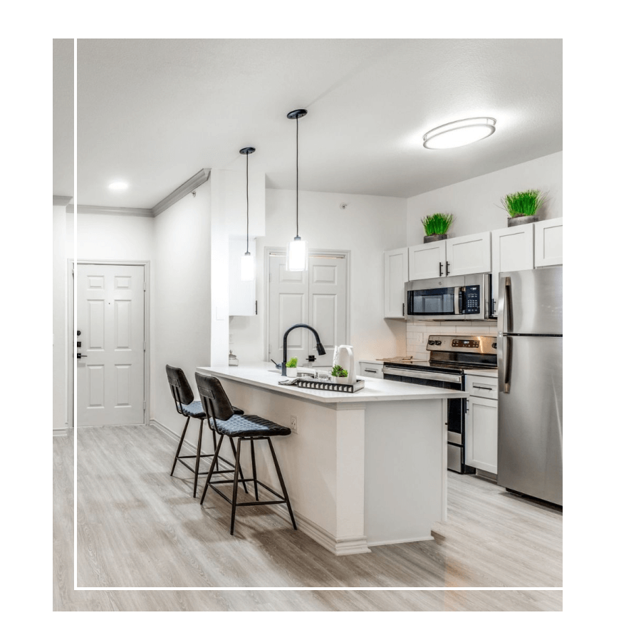 Kitchen with wood-style flooring, ample lighting and stainless steel appliances